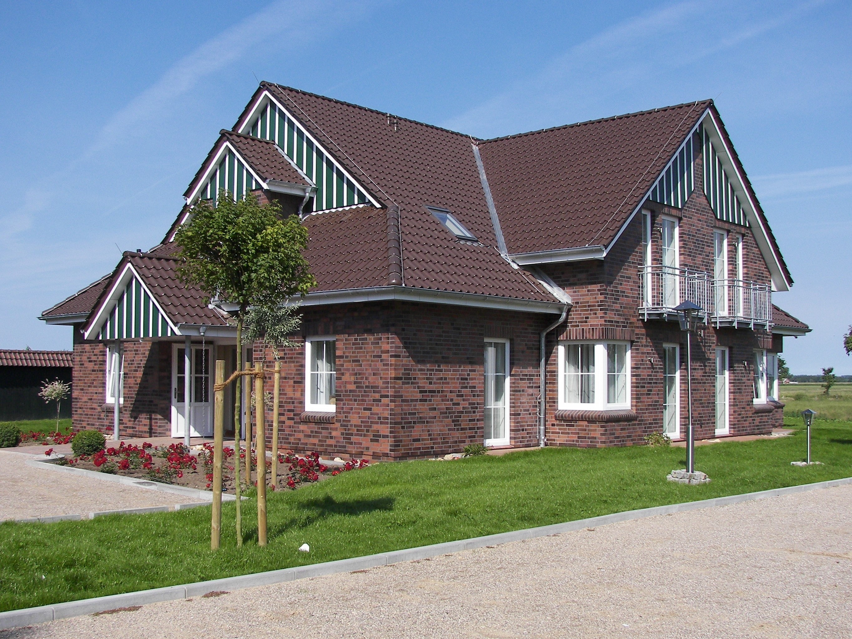 Hotelgebäude auf grüner Wiese und blauem Himmel. 